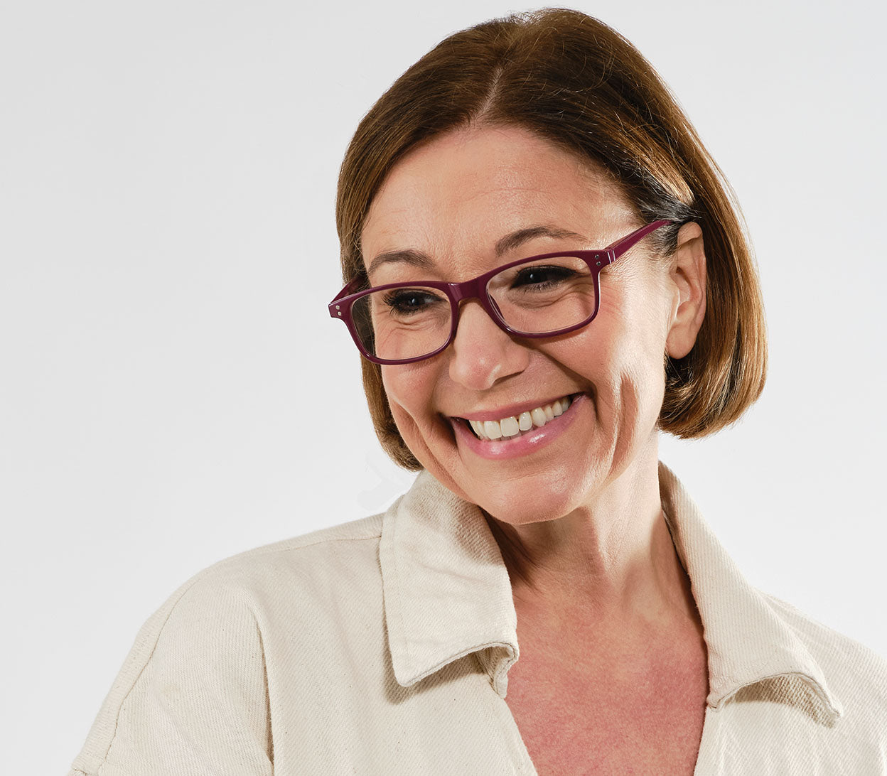 Female model wearing Eclipse (Purple) classic shaped reading glasses with oval lenses and a gloss purple frame.