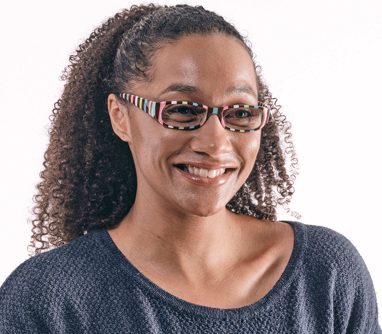 Female model wearing Shandy (Multi-coloured) classic women's reading glasses with striped multicoloured frames and a glossy finish.