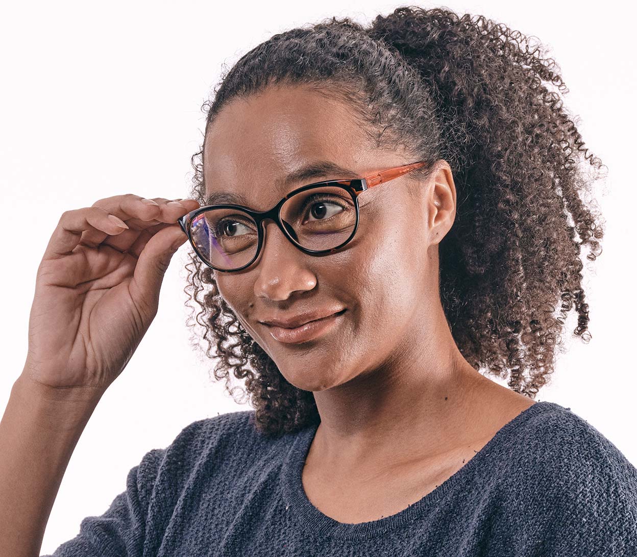 Female model wearing Lala Digital (Orange) cat eye shaped, women's reading glasses with a two tone tortoiseshell and orange frame and blue light lenses.