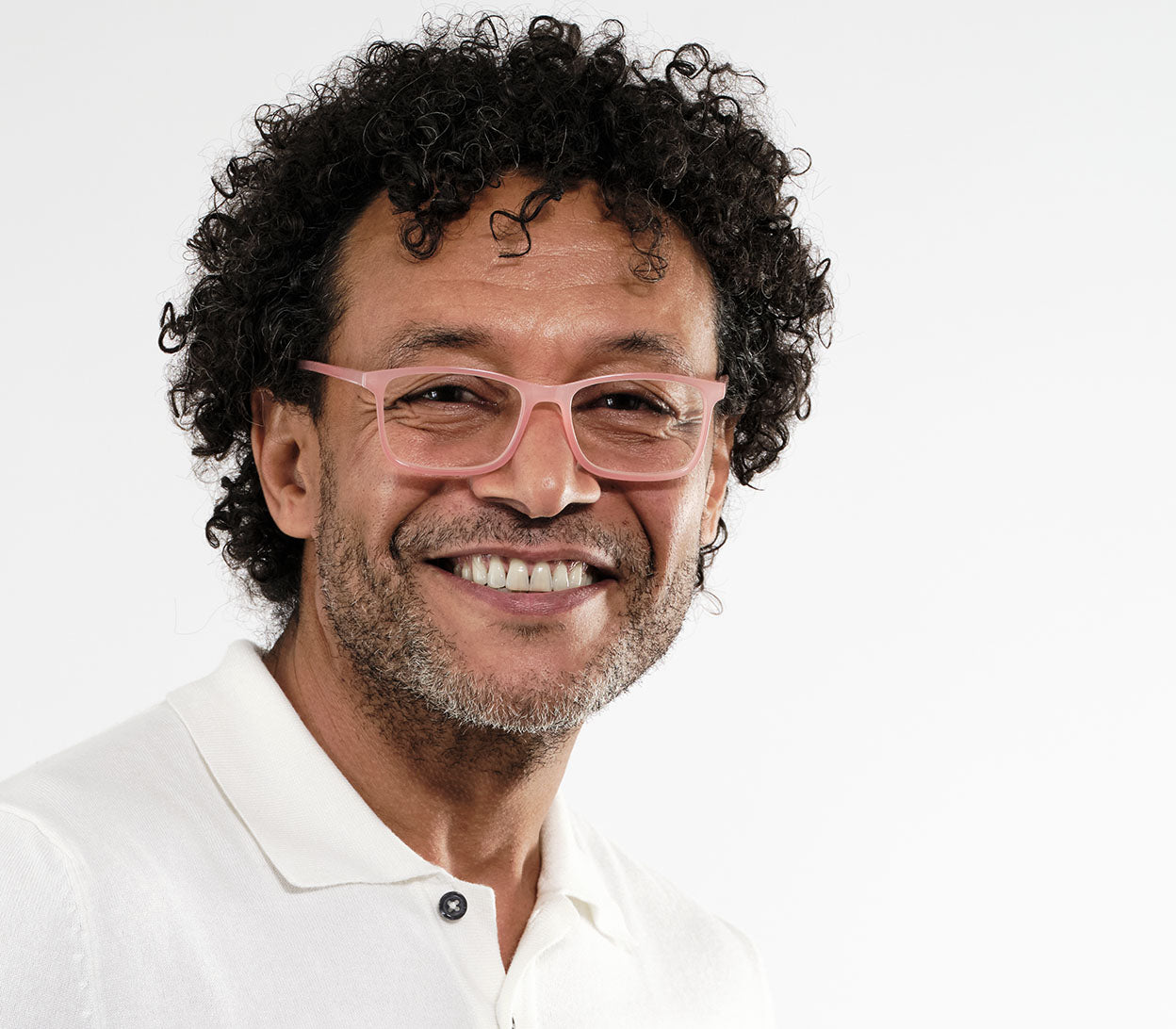 Male model wearing Sundae (Coral) classic shaped unisex reading glasses with a light slender frame and rectangular lenses.