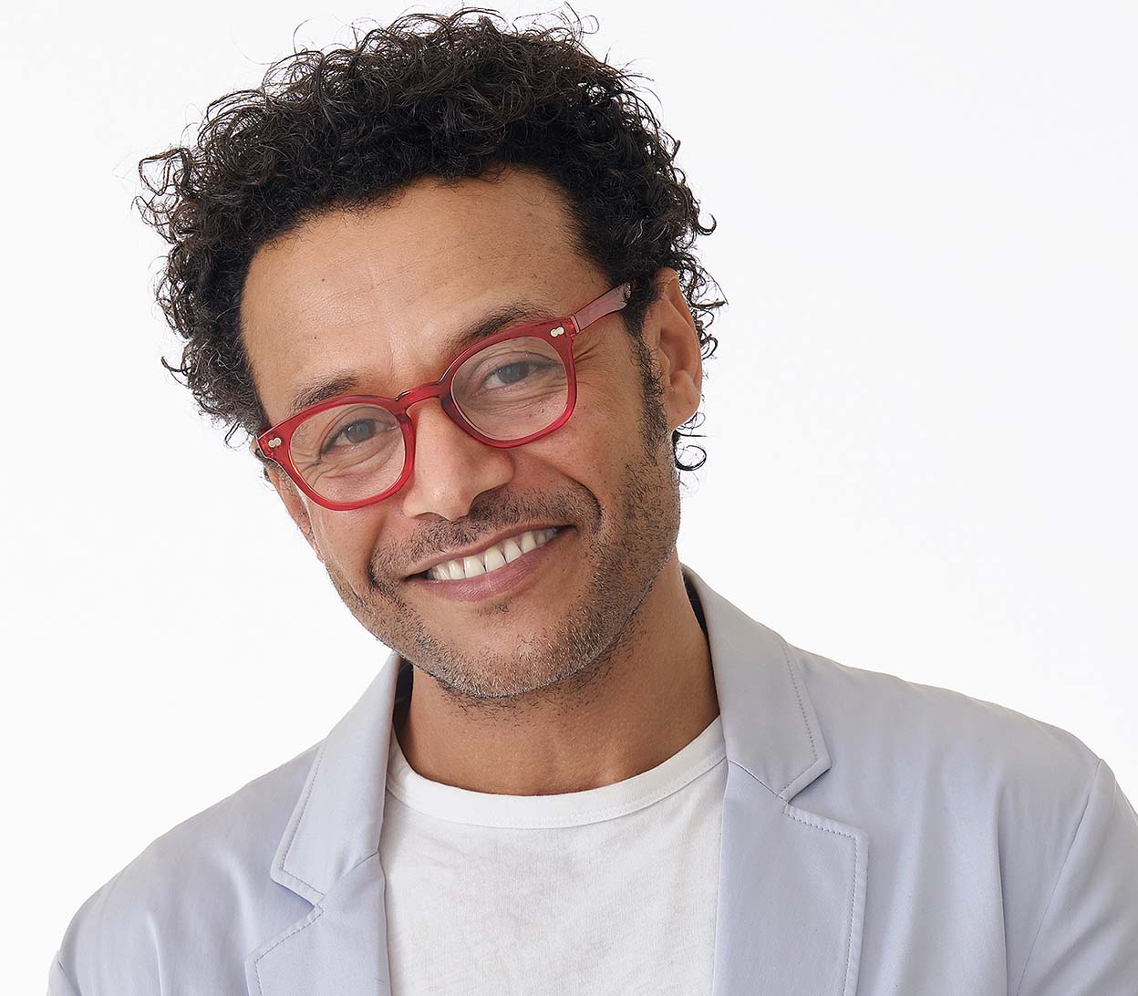 Male model wearing Lollipop (Red) chunky retro, unisex reading glasses. Bright red frames with rivet details.