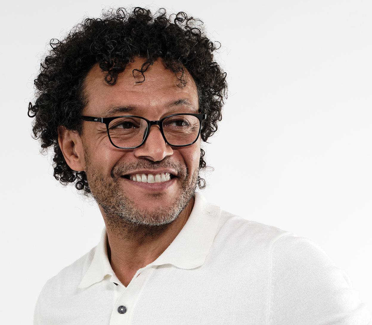 Male model wearing Artist Bifocal (Black) unisex reading glasses with glossy frame. Oval, bifocal lenses.