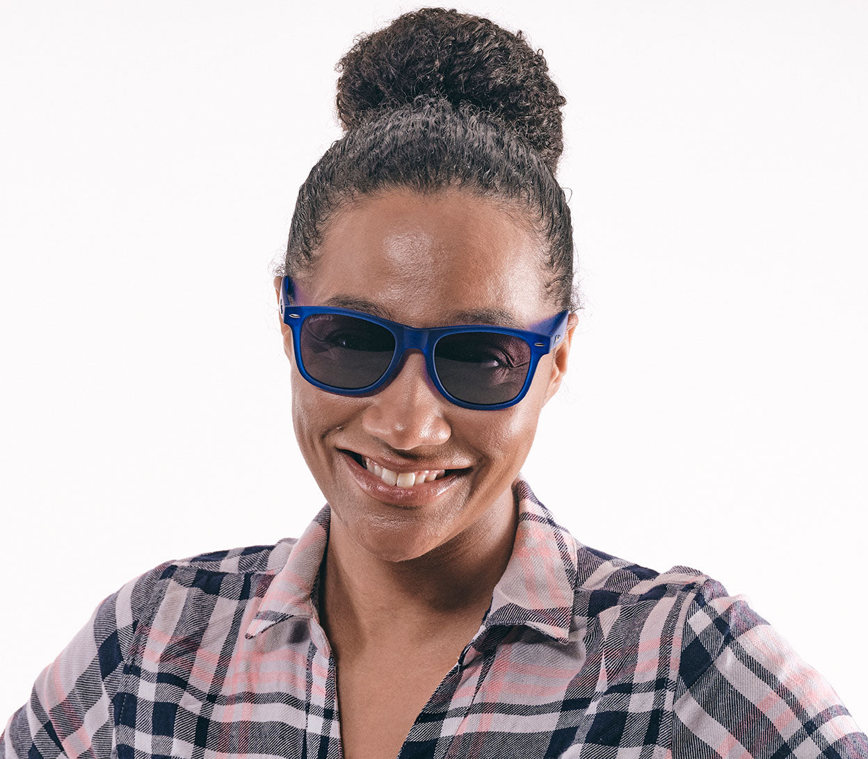 Female model wearing Osaka (Blue) classic wayfarer shape sunglasses with oval, grey tinted lenses and bright blue frames.