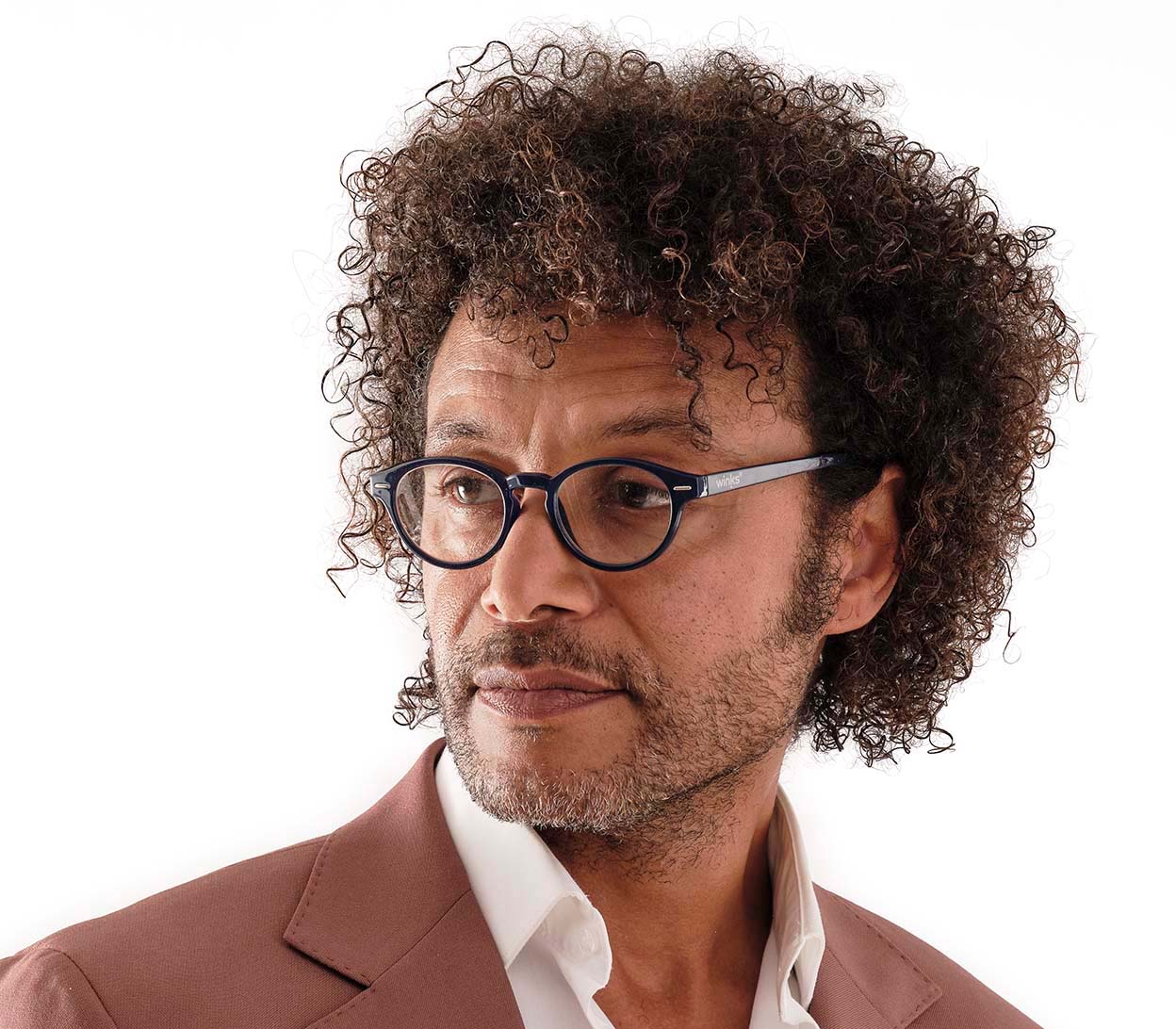 Male model wearing Espresso (Blue) unisex reading glasses with a dark blue frame and round, retro lenses.