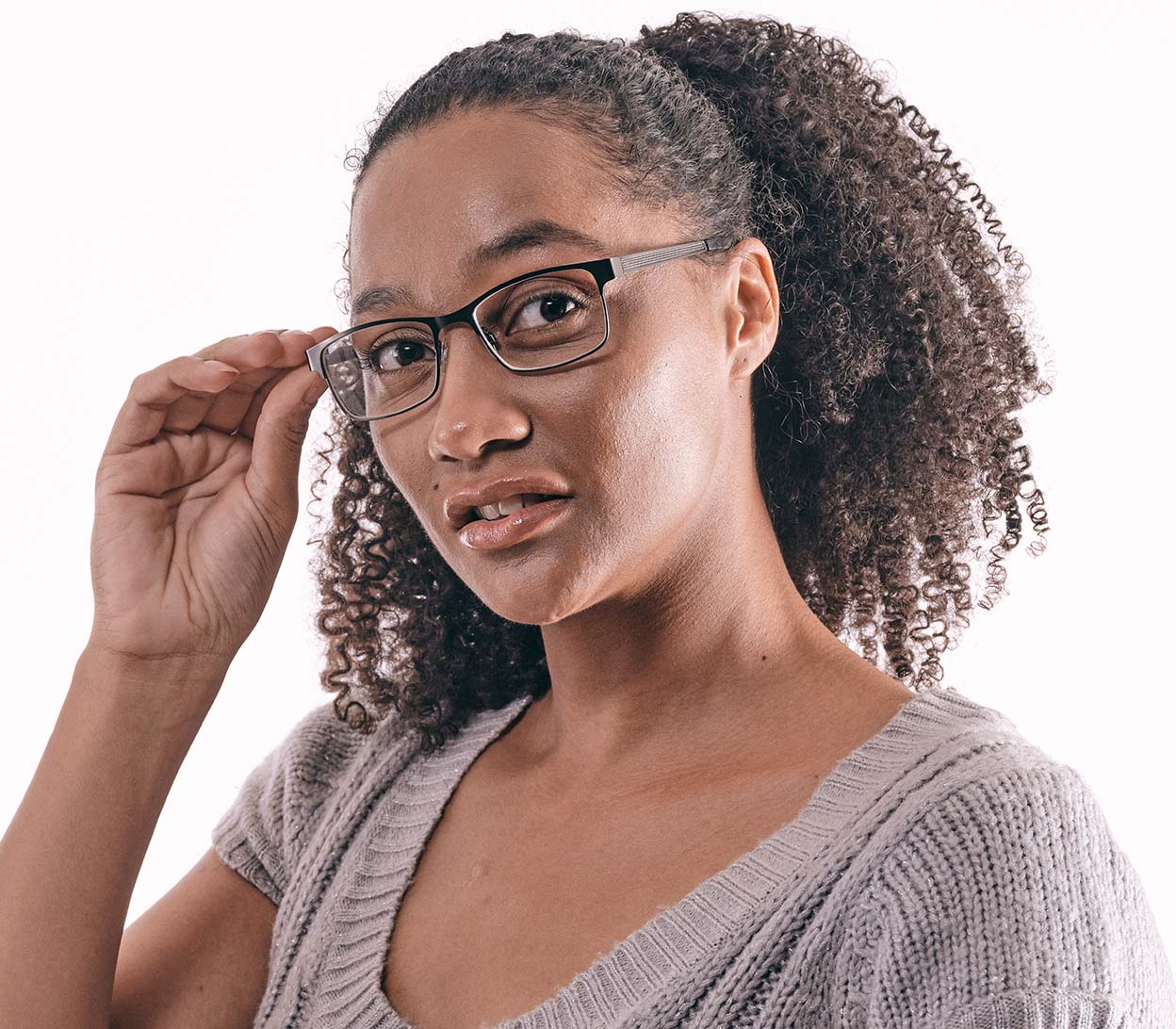 Female model wearing Washington (Gunmetal) rectangular classic gunmetal reading glasses. Slender frames and adjustable nose pads.