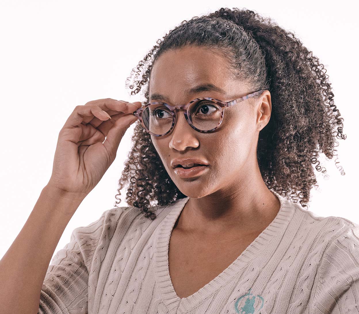 Female model wearing Oskar (Multi Tortoise) unisex reading glasses with large round lenses and a colourful tortoiseshell frame.