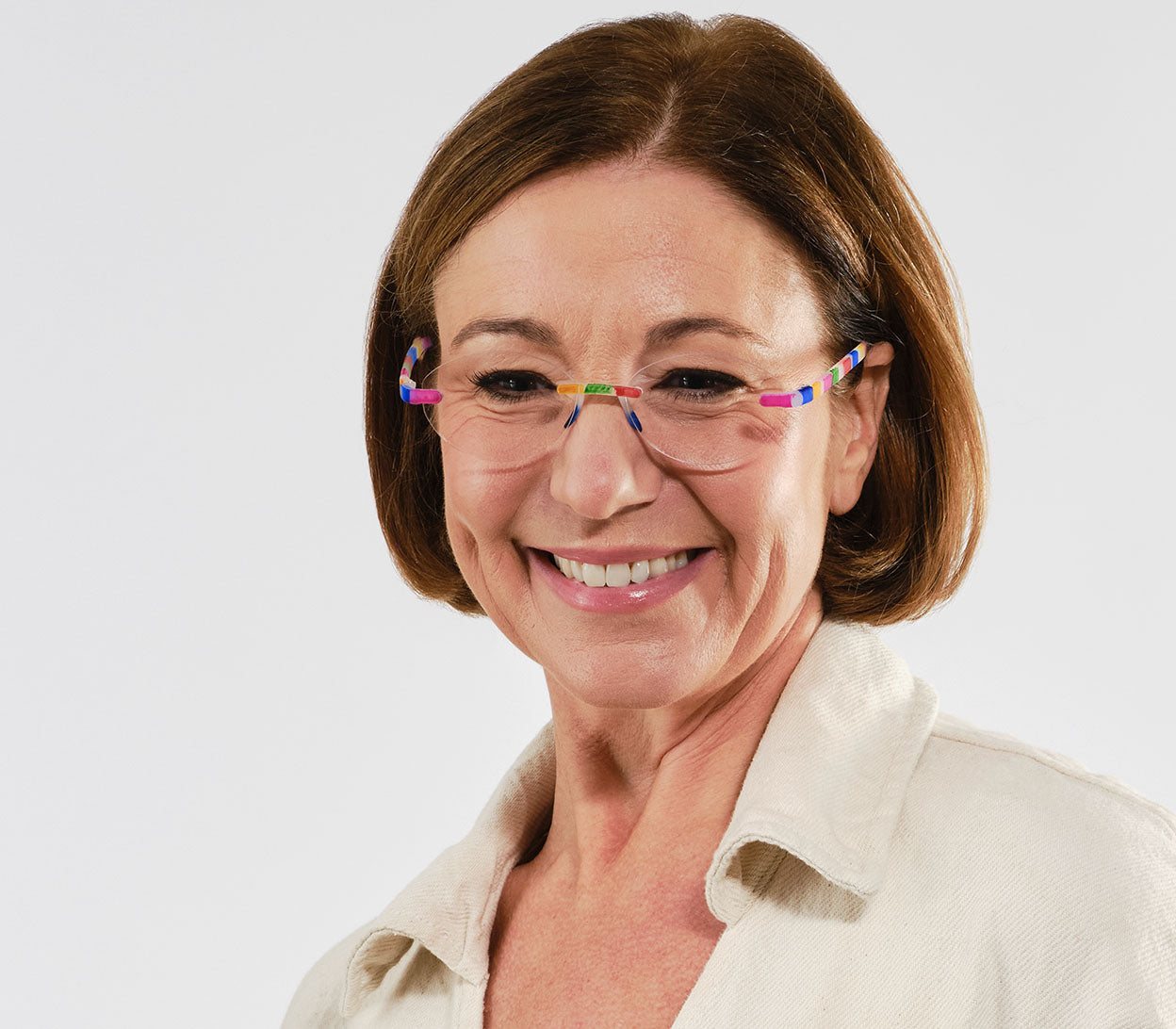 Female model wearing Jelli Solo (Multi-Coloured) round, rimless reading glasses with soft touch finish, fun multicoloured details.