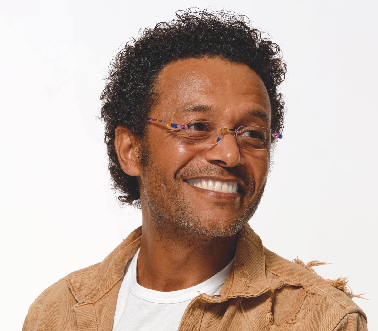 Male model wearing Jelli (Multi-coloured) rimless, slim reading glasses with semi translucent, multicoloured arms and bridge.