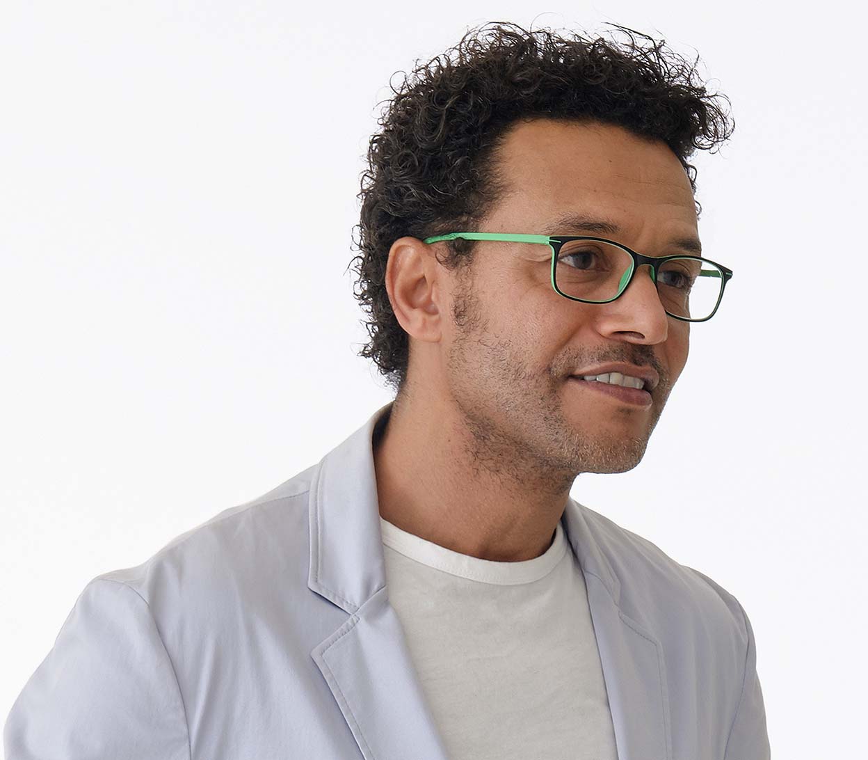 Male model wearing Jazz (Green) classic shape reading glasses with rectangular lenses in a two tone green and black frame.
