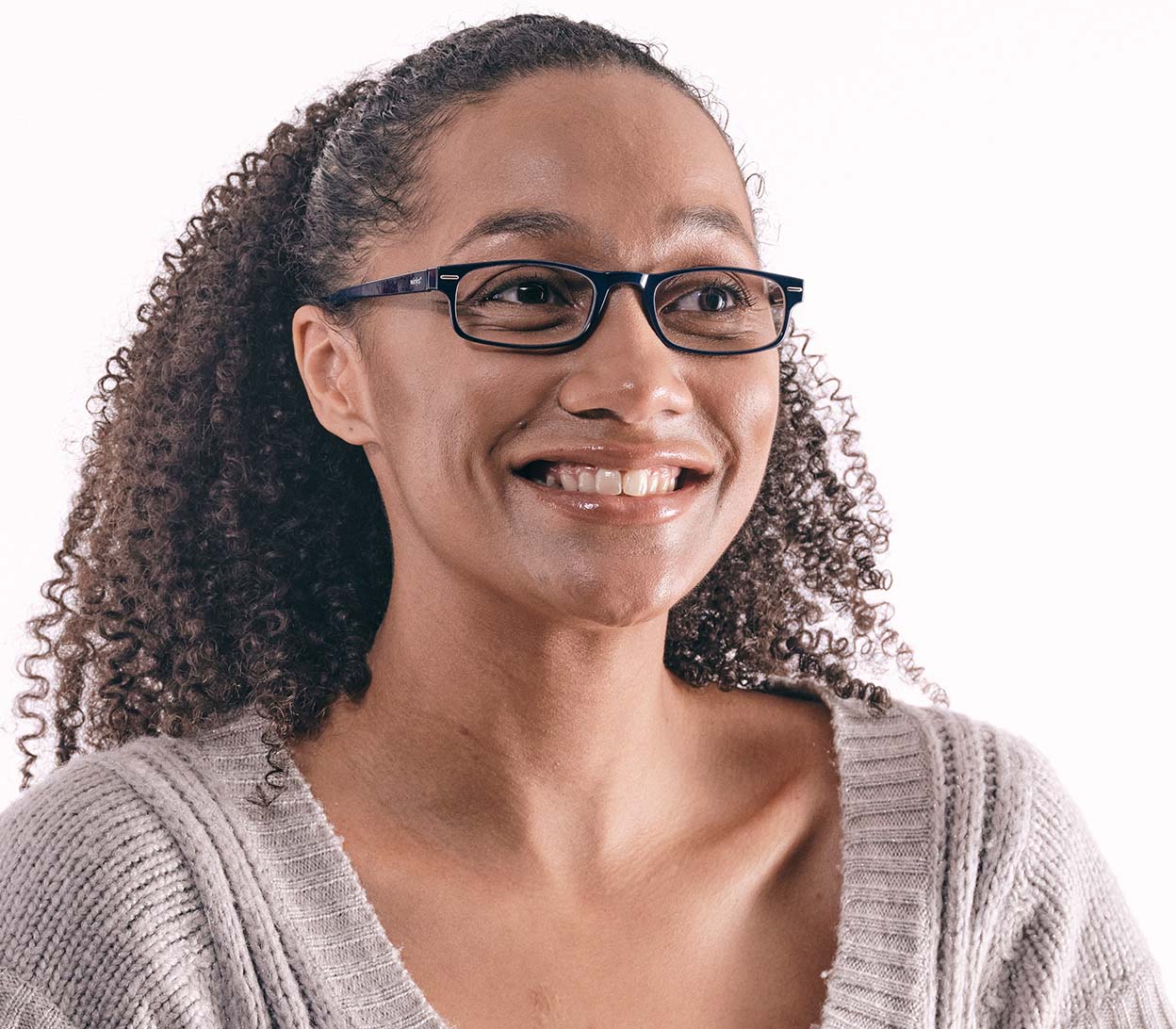 Female model wearing London (Blue) classic rectangular and slim unisex reading glasses in a deep blue glossy finish.