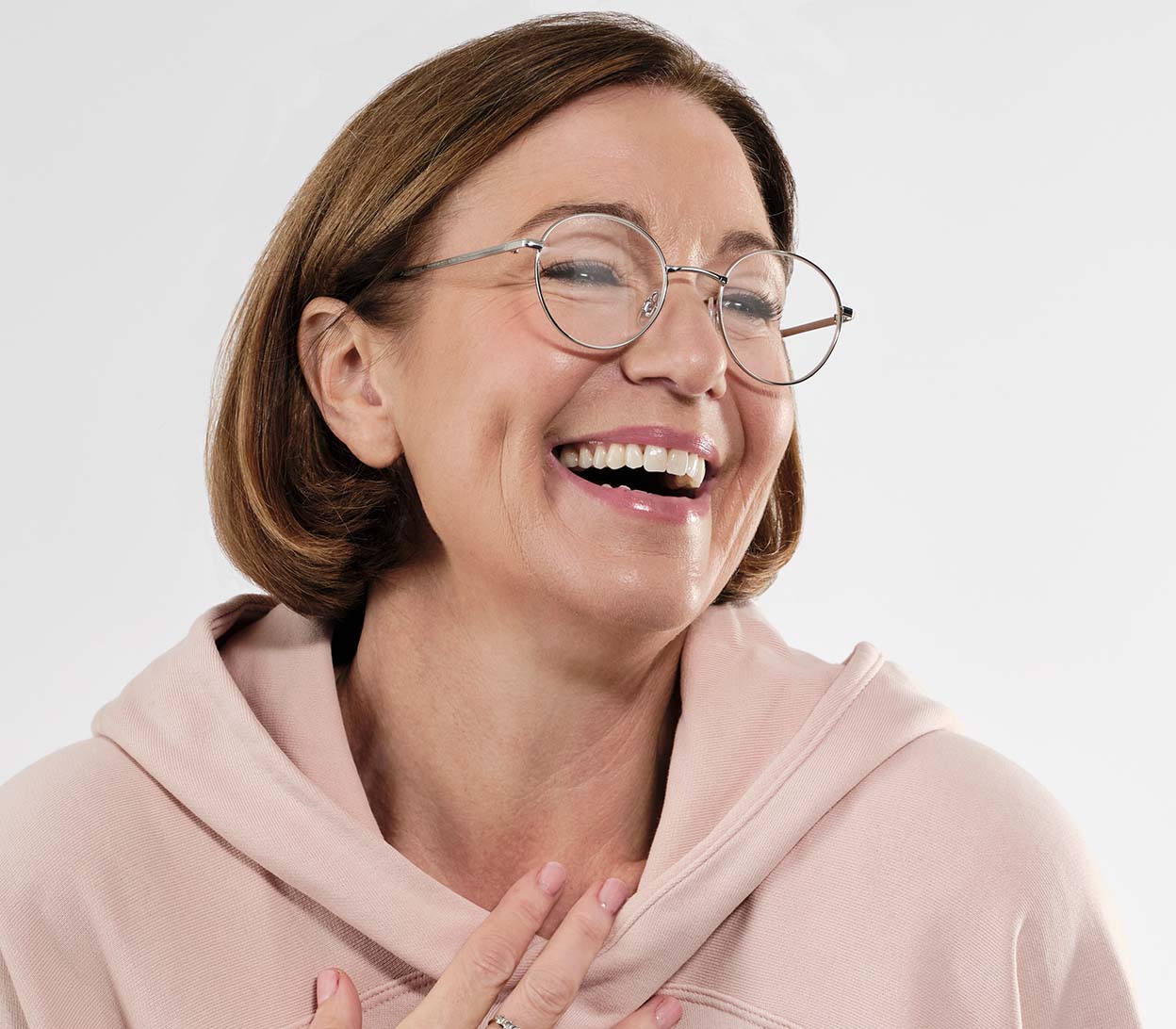 Female model wearing Wizard (Silver) round, metal framed reading glasses with adjustable nose pads.