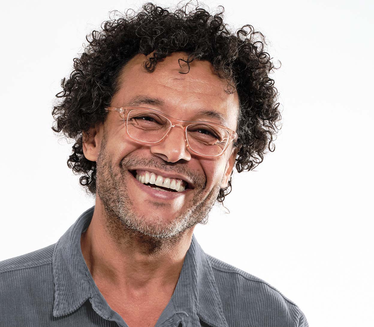 Male model wearing Echo (Orange) classic shaped unisex reading glasses with a pale orange, translucent frame.