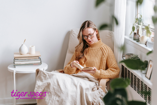 A women reading a book in a peaceful home setting.
