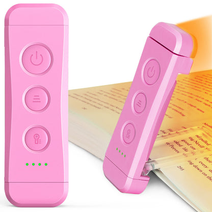 Beam Mini (Pink) mini LED reading light clipped onto a book.