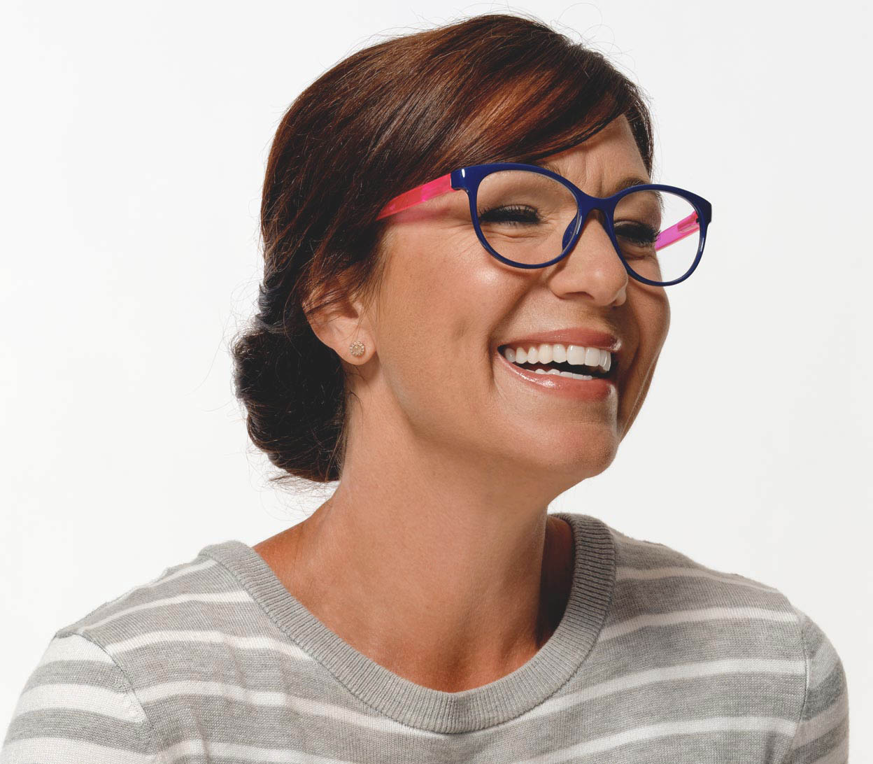 Female model wearing Angel (Blue) womens cat eye style reading glasses with blue frames and pink arms.