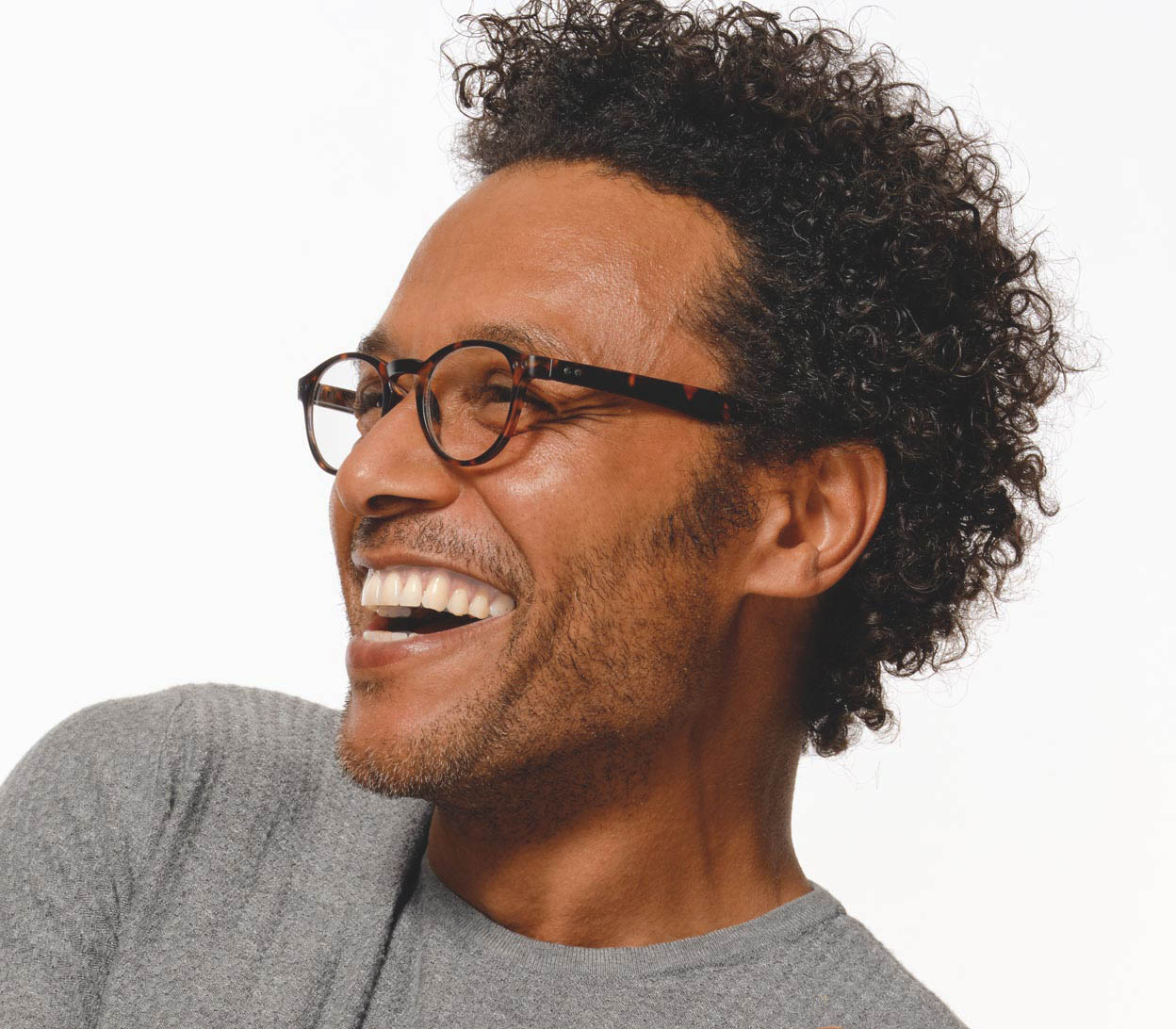 Male model wearing Jigsaw (Tortoiseshell) retro style reading glasses with round lenses and extra long arms for hanging around the neck when not being used.