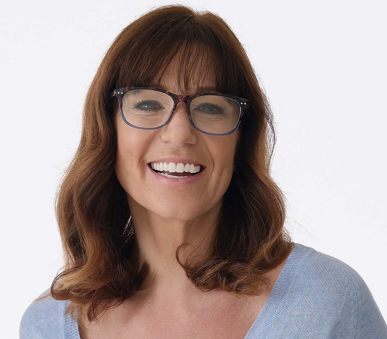 Female model wearing Aspen (Blue) women's retro style reading glasses. Multicoloured frames and a glossy finish. Large oval shaped lenses.