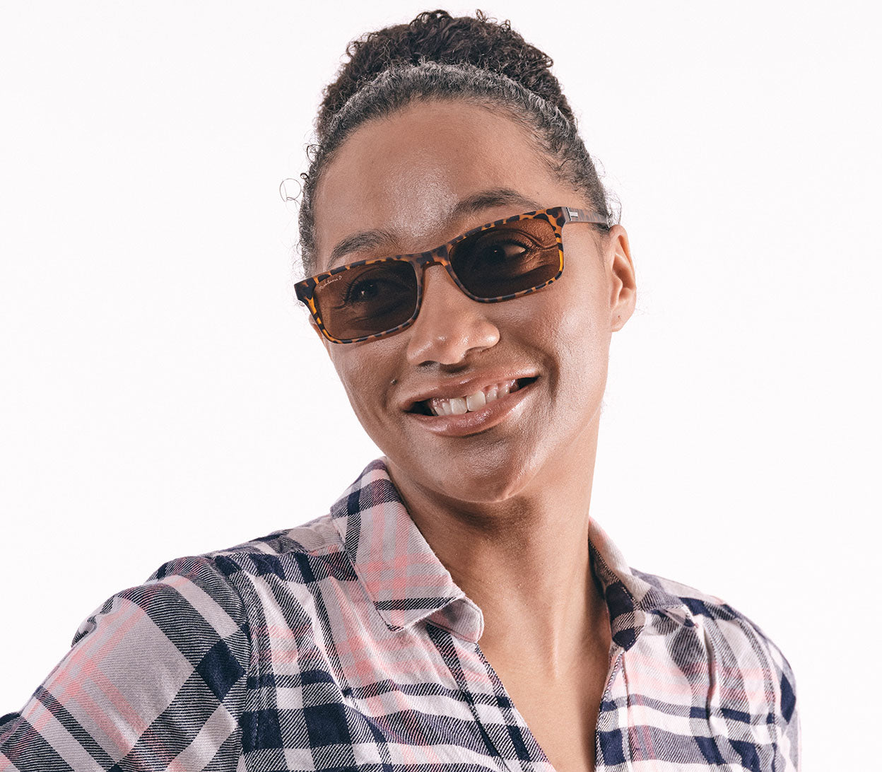 Female model wearing Sunlight (Tortoiseshell) classic unisex reading glasses with rectangular brown tinted lenses and a bold tortoiseshell frame.