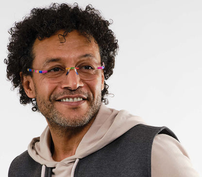 Male model wearing Jelli Solo (Multi-Coloured) round, rimless reading glasses with soft touch finish, fun multicoloured details.