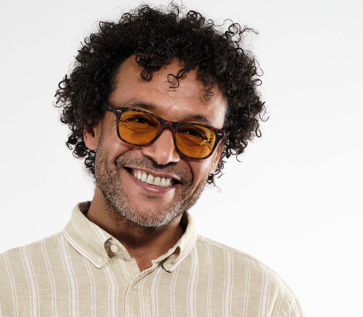 Male model wearing Grid (Tortoiseshell) classic wayfarer shaped night driving glasses. Wide arms and tortoiseshell pattern.