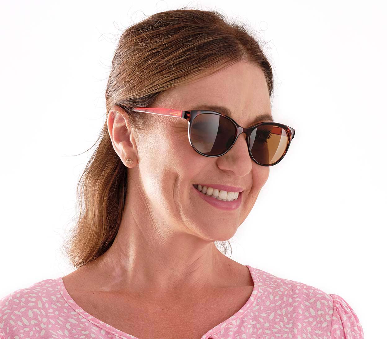 Female model wearing Naomi (Orange) women's cat eye sunglasses with tortoiseshell frame and orange temples. Round brown tinted lenses.