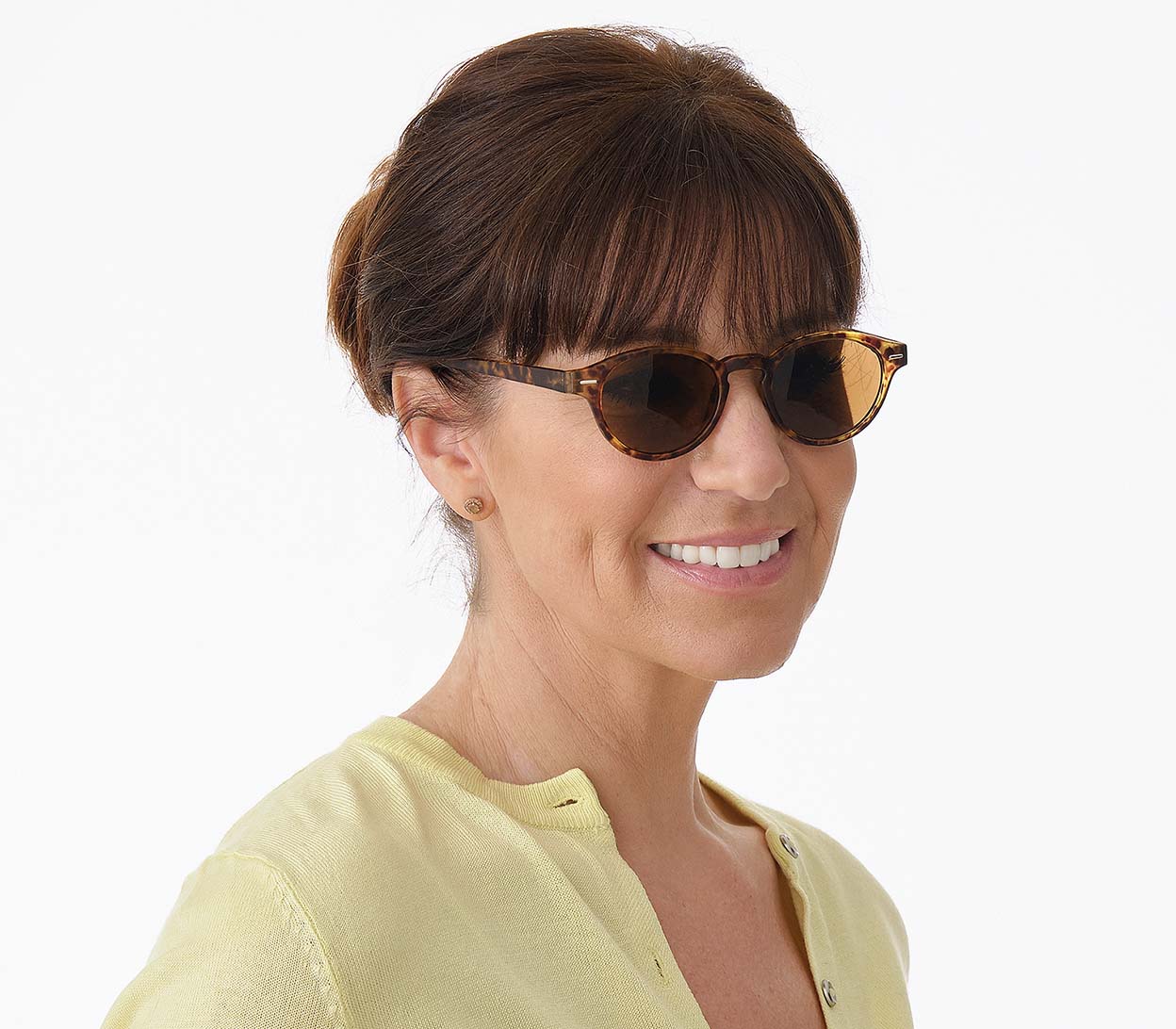 Female model wearing Montpellier (Tortoiseshell) retro style sunglasses in a rich tortoiseshell finish. Round, brown tinted lenses.