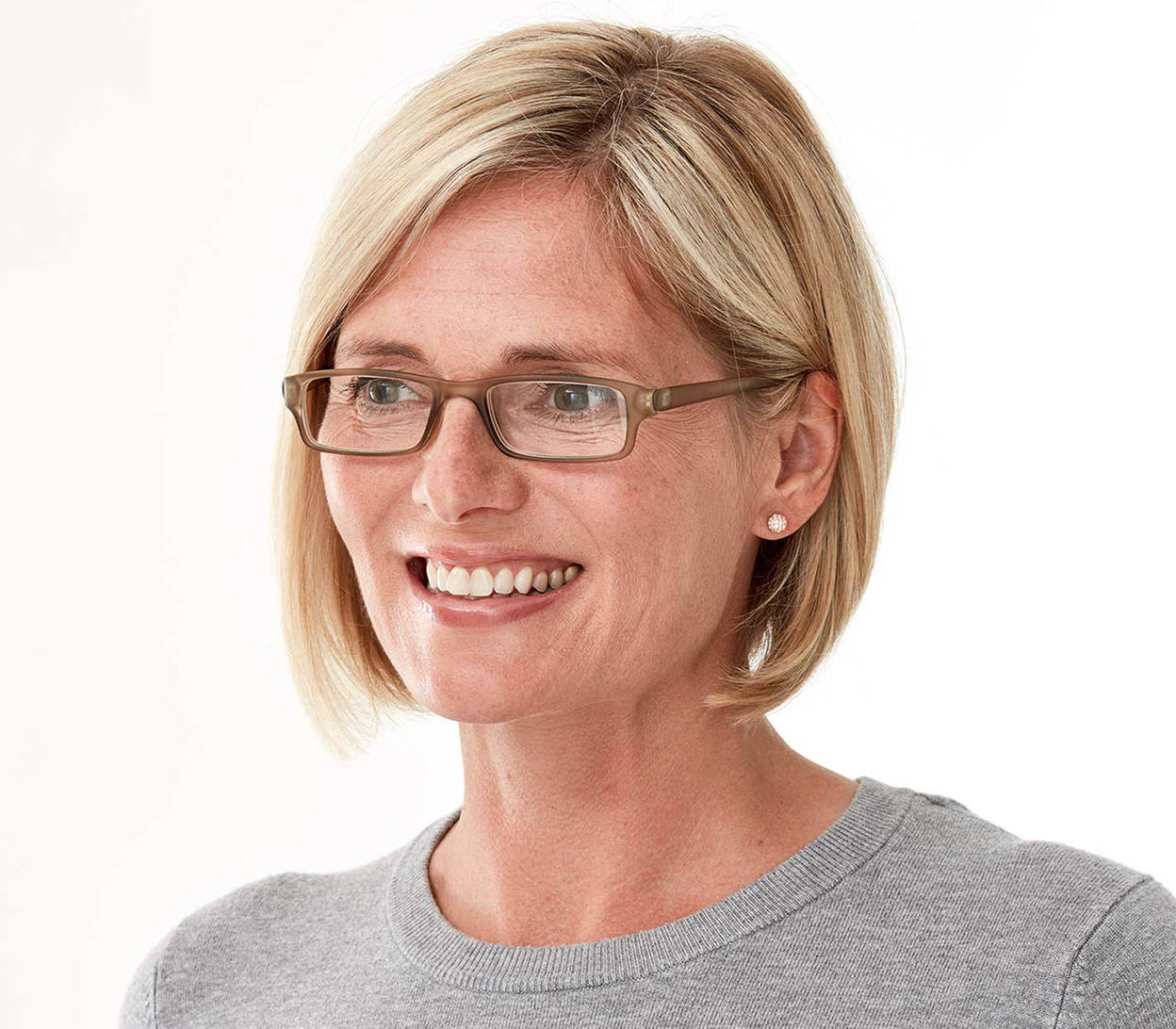 Female model wearing Action (Grey) unisex reading glasses. Classic shaped glasses with a smooth grey finish.