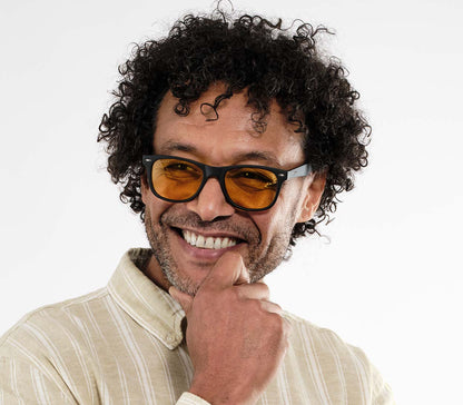 Male model wearing Grid (Black) classic wayfarer shaped night driving glasses.