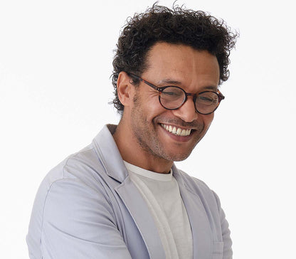 Male model wearing Oskar (Tortoiseshell) unisex reading glasses with large round lenses and soft touch deep tortoiseshell frames.