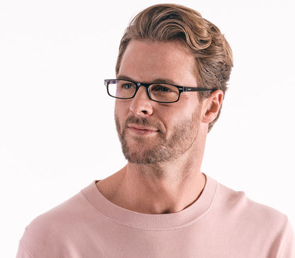 Male model wearing London Digital (Black) classic rectangular and slim unisex blue light reading glasses in a glossy black finish.