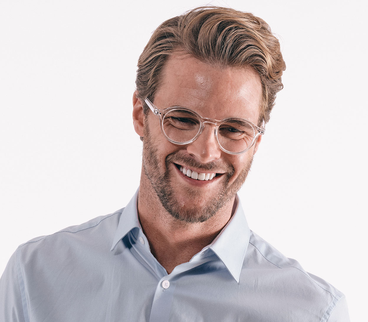 Male model wearing Oskar (Clear) unisex reading glasses with large round lenses and a clear frame.