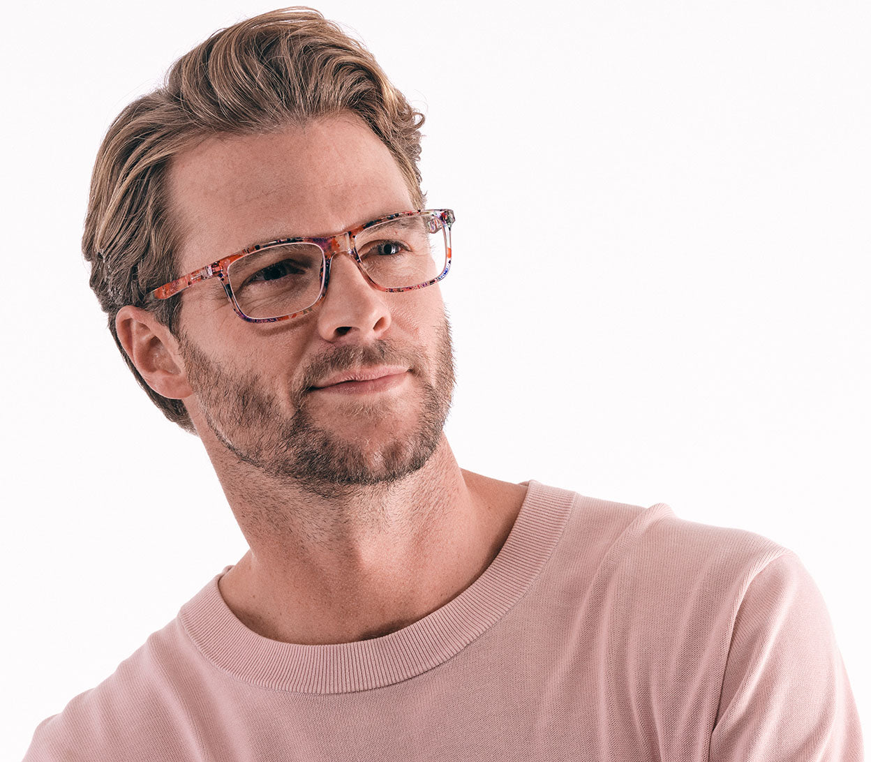 Male model wearing Dexter (Multi-coloured) classic shape unisex reading glasses with a translucent, glossy multicoloured frame.