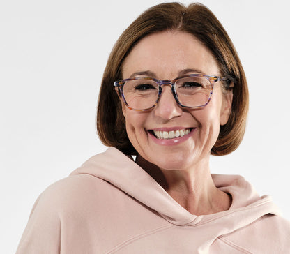Female model wearing Scholar (Multi-coloured) retro unisex reading glasses with large oval shaped lenses, slender patterned multi-coloured frame.