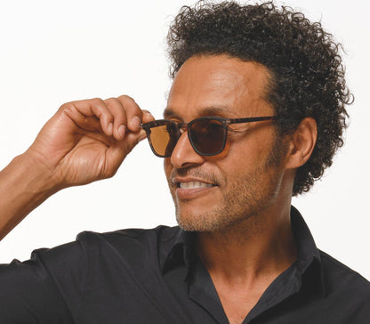 Male model wearing Torino (Tortoiseshell) retro tortoiseshell sunglasses with a slender and soft touch frame. Large brown lenses.