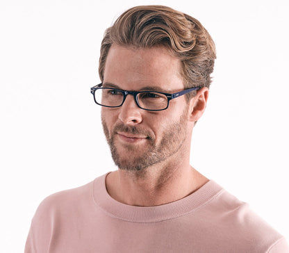 Male model wearing London (Blue) classic rectangular and slim unisex reading glasses in a deep blue glossy finish.