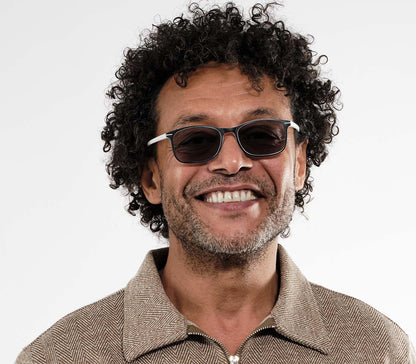 Male model wearing Esprit (White) sunglasses with two tone white and black frames and temples. Classic shaped lenses with a smoke grey tint.