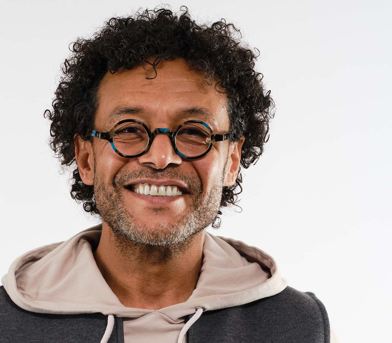 Male model wearing Snowball (Blue Tortoise) vintage style unisex reading glasses with round lenses and luxury blue tortoiseshell frame.