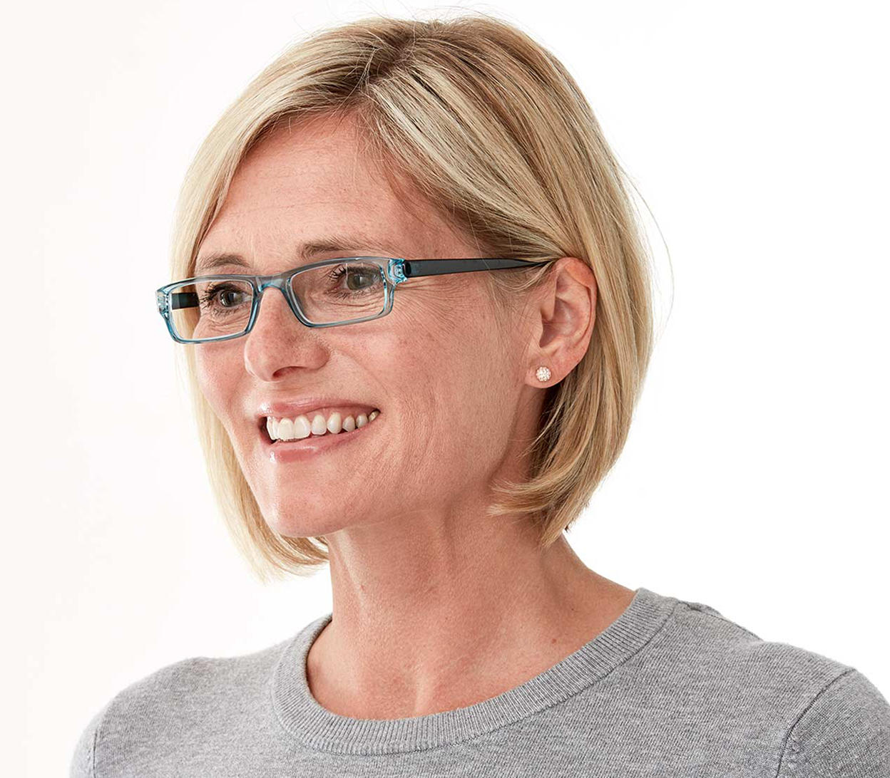 Female model wearing Action (Blue) unisex reading glasses. Classic shaped glasses with a blue translucent finish.