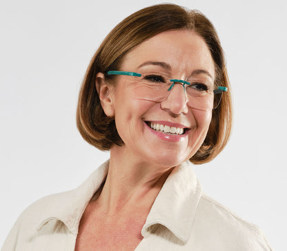 Female model wearing Jelli Max (Turquoise) square, rimless reading glasses with large lenses and turquoise details.