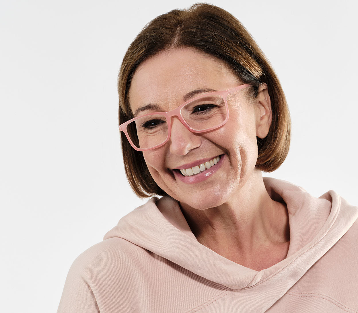 Female model wearing Sundae (Coral) classic shaped unisex reading glasses with a light slender frame and rectangular lenses.
