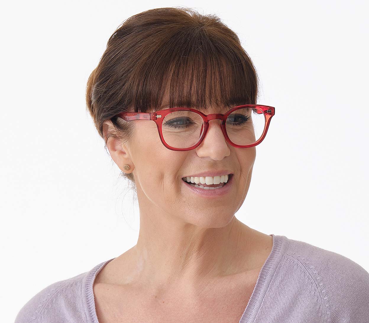 Female model wearing Lollipop (Red) chunky retro, unisex reading glasses. Bright red frames with rivet details.