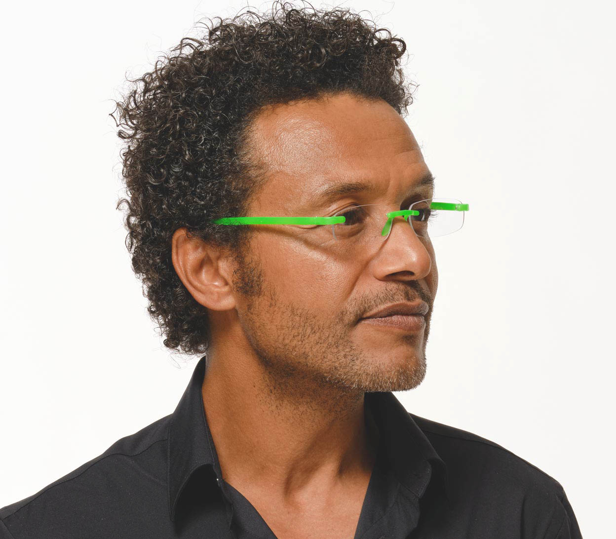 Male model wearing Jelli Neon (Green) rimless, slim reading glasses with semi-translucent bright green arms and bridge.