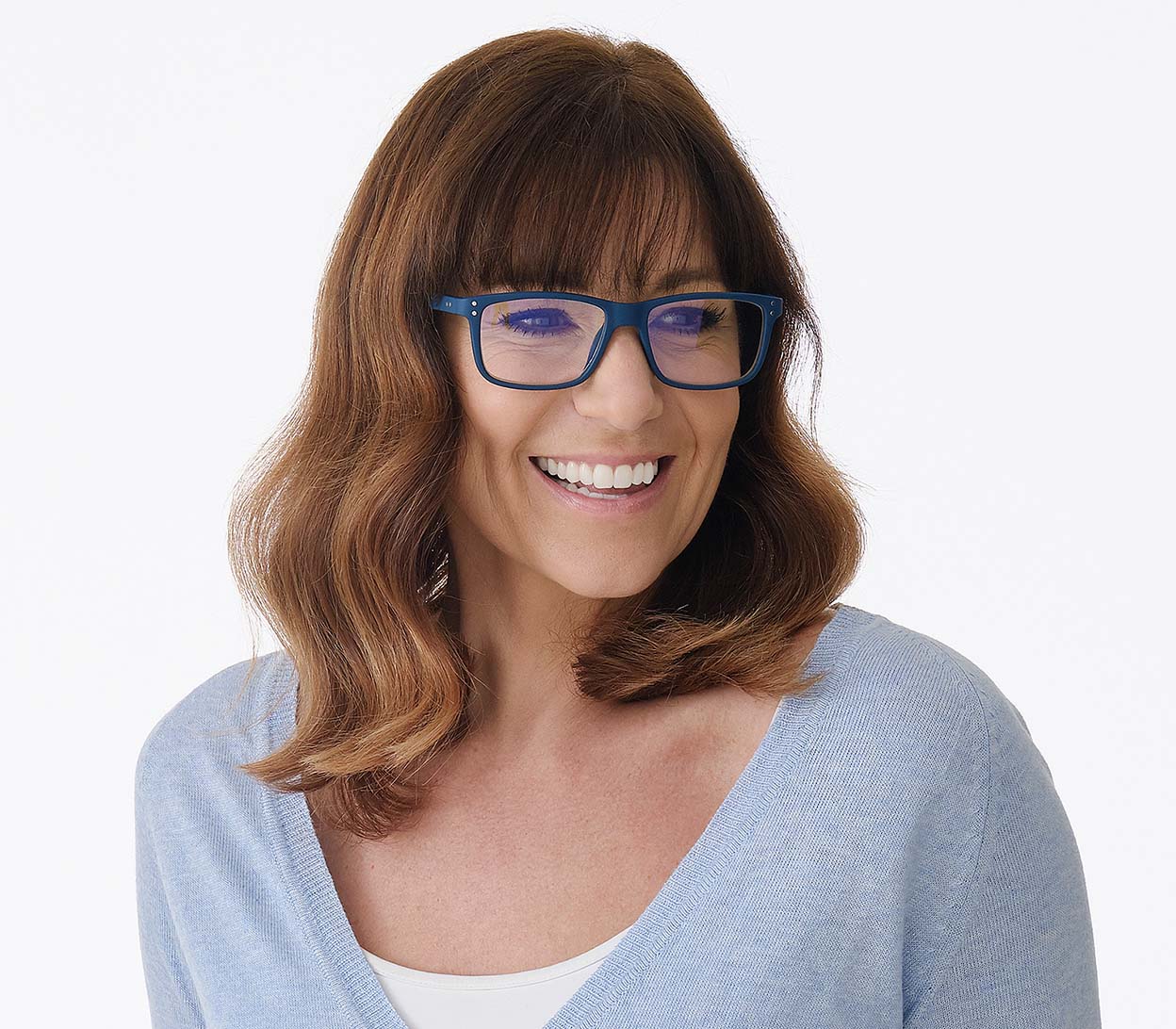 Female model wearing Austin (Blue) classic shaped, unisex blue light glasses. Deep blue frames with soft touch finish and rivet details.