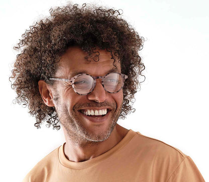 Male model wearing Oskar (Grey Tortoise) unisex reading glasses with large round lenses and grey tortoiseshell frames.
