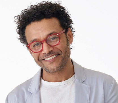Male model wearing Lollipop (Red) chunky retro, unisex reading glasses. Bright red frames with rivet details.