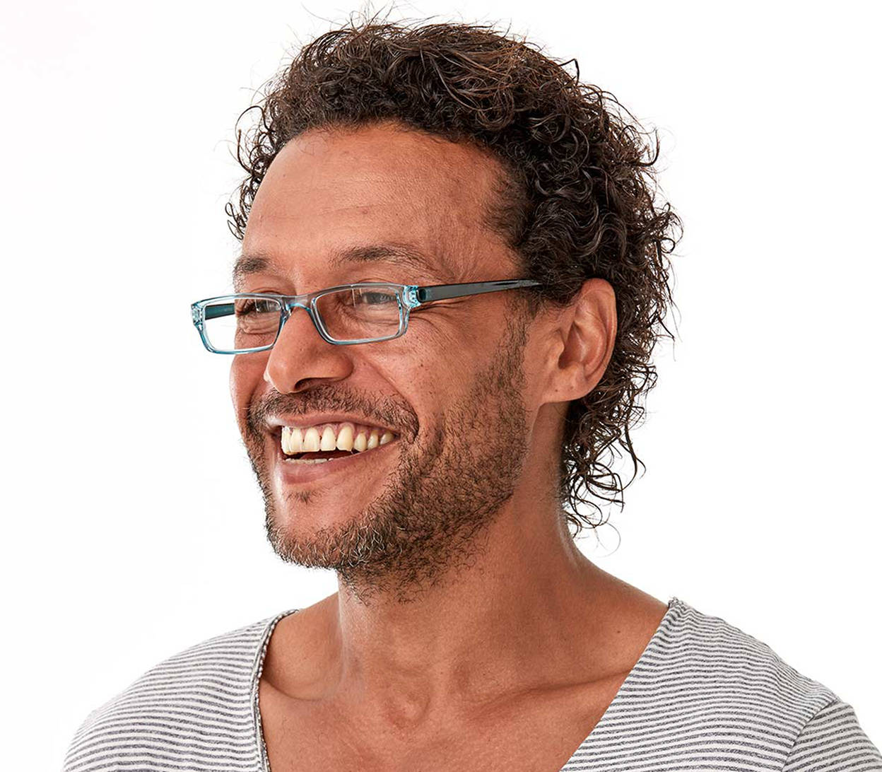 Male model wearing Action (Blue) unisex reading glasses. Classic shaped glasses with a blue translucent finish.