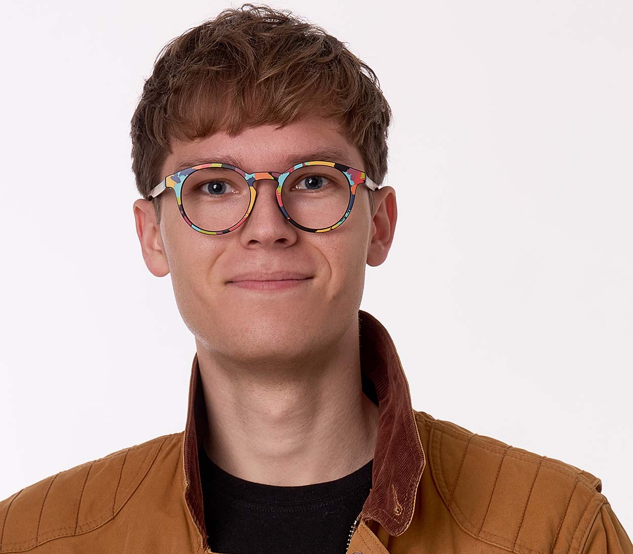 Female model wearing Fantasy (Multi-coloured) unisex, multicoloured reading glasses with a distinctive pattern and classic shaped round lenses.