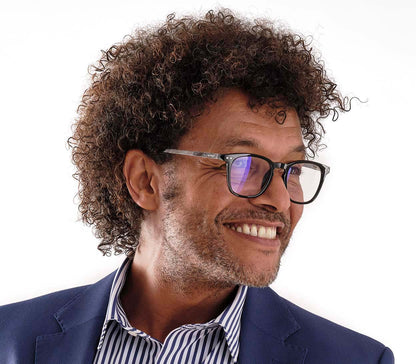 Male model wearing Helix (Black) retro shaped blue light reading glasses with black frames and chevron patterned arms.