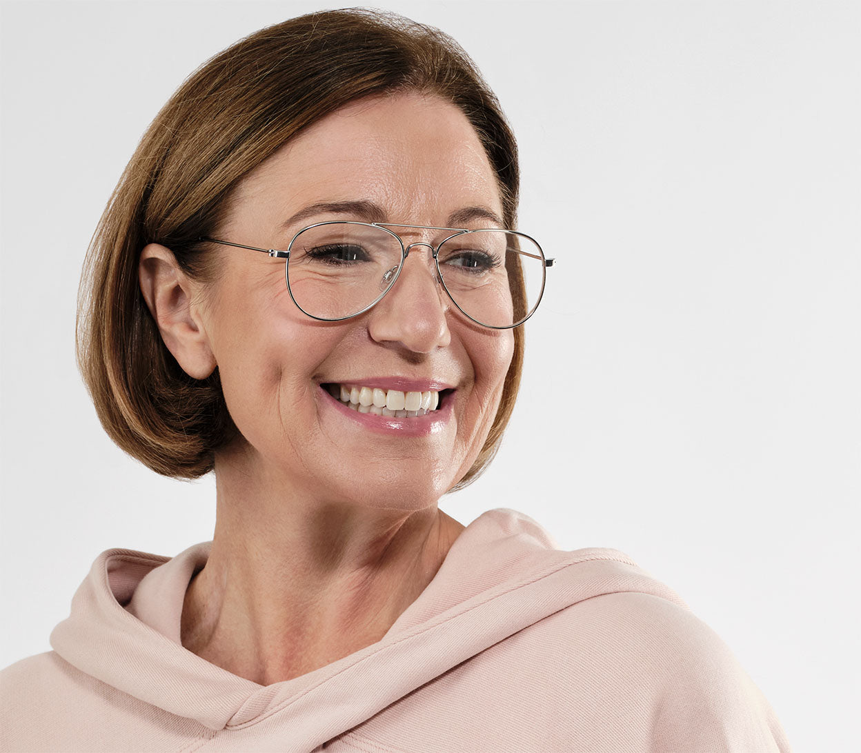 Female model wearing Mateo (Silver) classic aviator shaped reading glasses with a slim silver frame and oversized lenses.