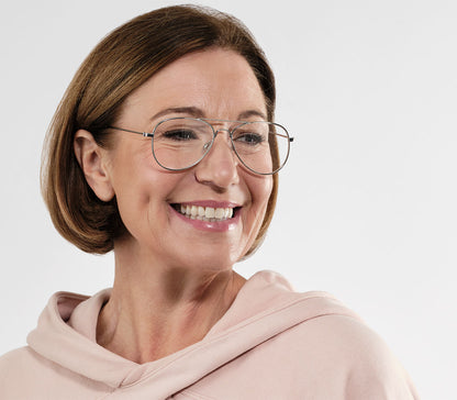 Female model wearing Mateo (Silver) classic aviator shaped reading glasses with a slim silver frame and oversized lenses.